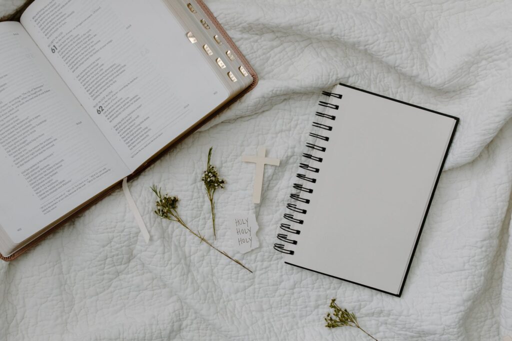 white notebook on white textile