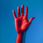 persons left hand with red paint